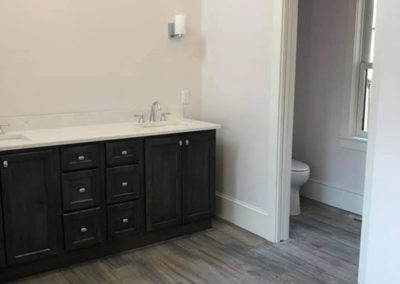 picture of simple bathroom with vanity and small room for the toilet