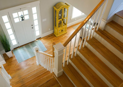 picture of grand staircase looking down to the front door- ocean getaway
