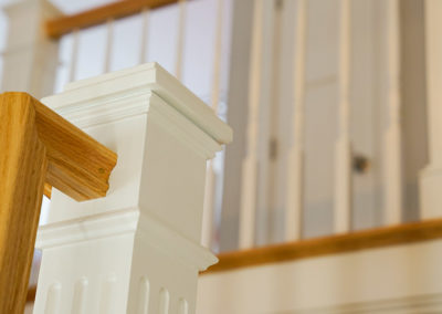 picture of a close-up on one of the staircase posts and molding- ocean getaway