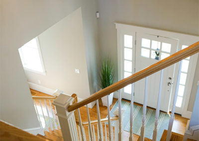 picture of the main staircase looking down at the front door-ocean getaway