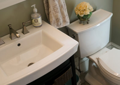 picture of small sink vanity and toilet- cape seashore home