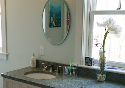 picture of bathroom vanity with green granite countertops- cape seashore home