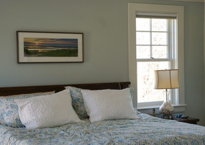 picture of a queen size bed with a blue bedspread - cape seashore home