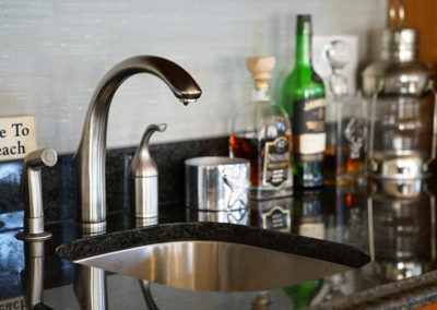 picture of a small kitchen sink with a granite countertop- cape seashore home