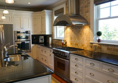 picture of a kitchen with dark granite countertops- cape seashore home