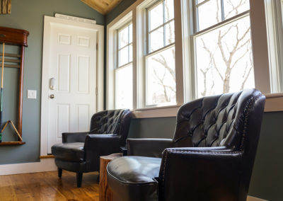 picture of 2 leather chairs under windows- cape seashore home